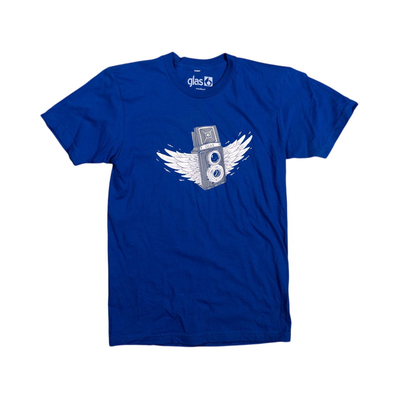 Glas Apparel blue cotton Wing Flex Tee featuring a white graphic of a vintage camera with wings on a wooden floor
